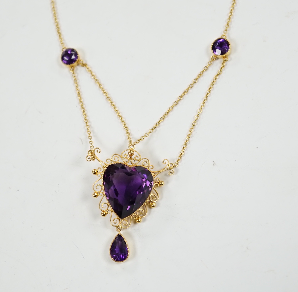 A Victorian style 9ct and four stone amethyst drop pendant necklace, the pendant set with heart shaped central stone and pear cut drop, overall 46cm, gross weight 8 grams.